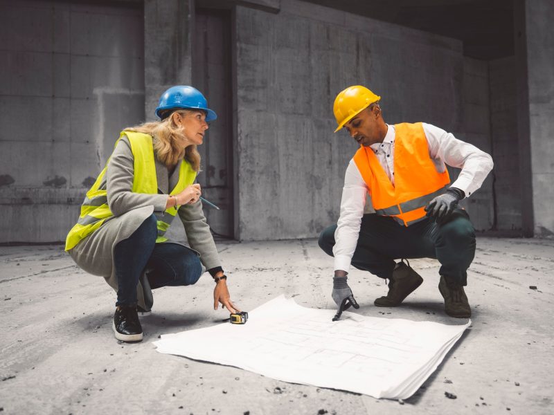 Construction industry and engineering - engineers, architects and contractors on the construction si